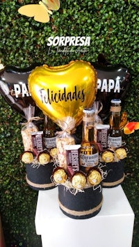 a gift basket filled with chocolates and balloons