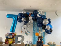 a space themed birthday party with balloons and decorations