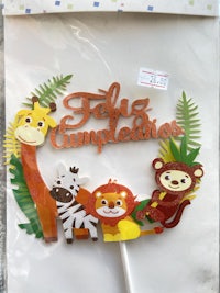 a cake topper with jungle animals on it