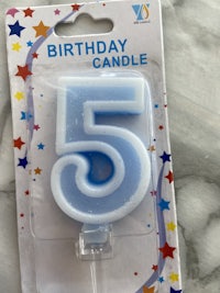 a blue birthday candle with stars on it