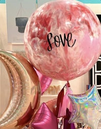 a group of balloons with the word love on them