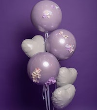 a bunch of purple balloons on a purple background