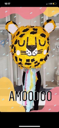 a woman is holding a pinata with a leopard on it